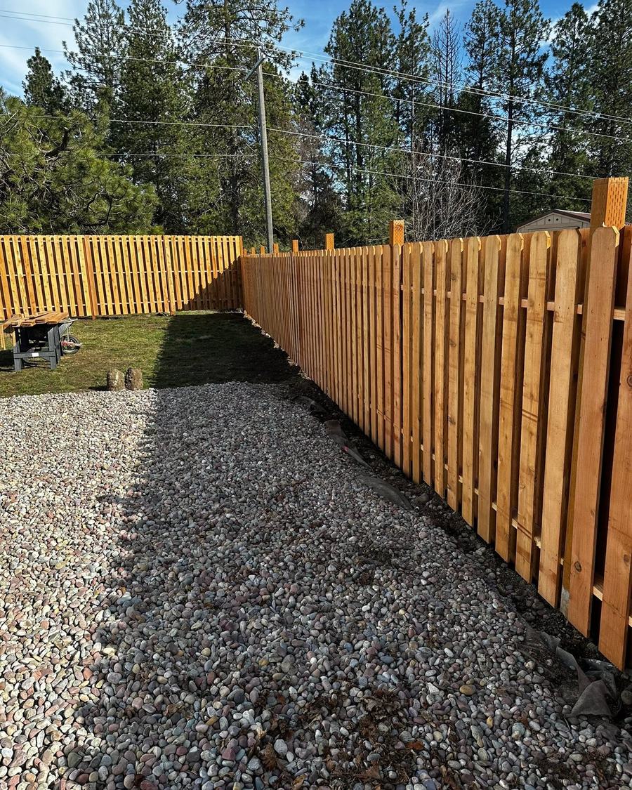 Shadow box cedar fence along a gravel drive, built by MC Fencing