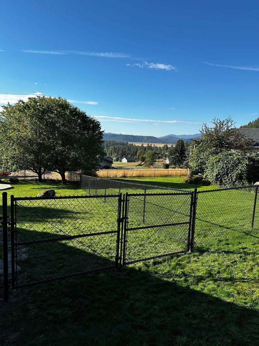 Black chain link fence with a double gate